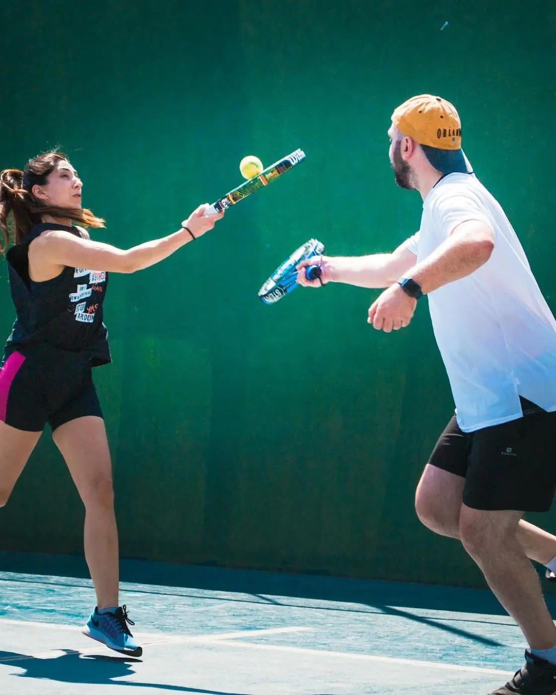 Padel player in mid-swing on an indoor court
